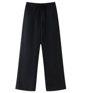 Detail of black wide-leg trousers with elastic drawstring waistband and textured fabric