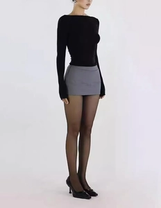 Detail of high-waist grey A-line mini skirt with anti-exposure lining and sleek fabric