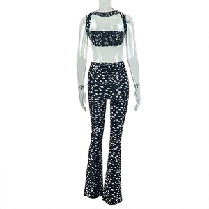 Detail of sexy two-piece set featuring backless halter top and polka dot flare pants