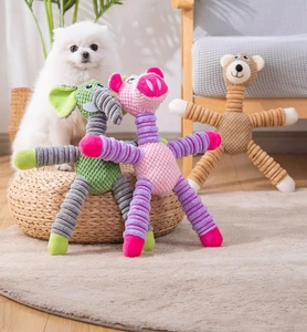 Detail of plush squeaky dog toys featuring long-limbed elephant, pig, and bear designs