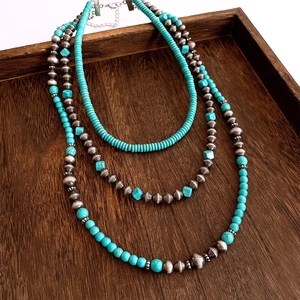 Detail of bohemian triple-layer necklace with turquoise beads and retro silver metal accents