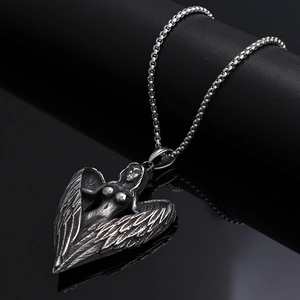 Vintage oxidized silver angel wings heart pendant necklace on dark reflective background