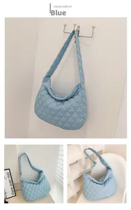 Detail view of light blue quilted nylon tote bag showing soft puffer texture and diamond stitch