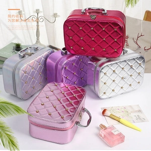 Quilted makeup bags with gold studs in various colors including rose red, silver, and purple