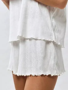 Detail showing white cotton loungewear set with pointelle knit texture and lettuce edges