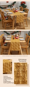 Detail of embroidered Christmas table runner with sequined 3D trees in ginger yellow plush