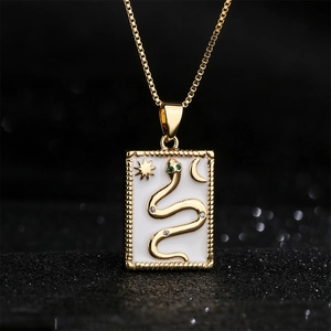 18K gold plated snake pendant necklace with white enamel and green gemstone details