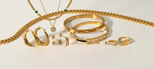 Detailed collection of 18K gold plated jewelry including necklaces, rings and bracelets