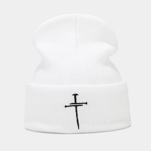 White knitted cuffed beanie with black nail cross embroidery for a vintage aesthetic style