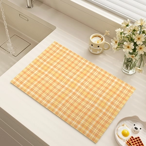 Absorbent kitchen counter drying mat with orange checkered pattern and daisy decor