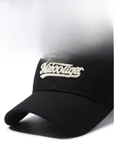 Detailed close-up of premium 3D white letter embroidery on black cotton baseball cap