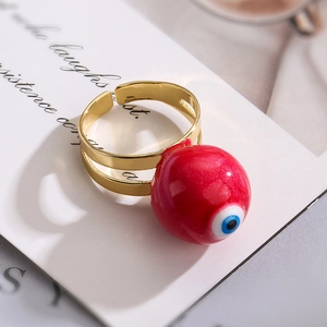 Detail of red enamel devil eye bead on a double-layered gold open ring for women