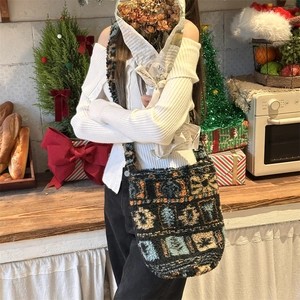 Plush bucket bag with geometric jacquard pattern shown in a festive holiday setting