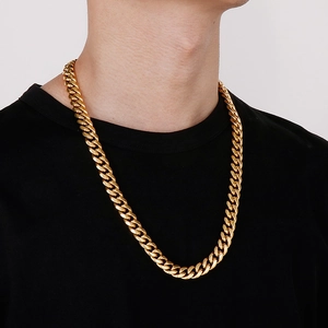 Detailed view of a thick gold Cuban link chain necklace worn by a male model