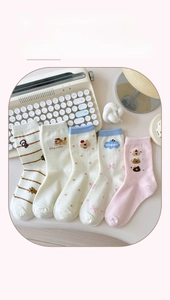 Set of five cotton socks featuring cute dog and stripe patterns in soft pastel tones