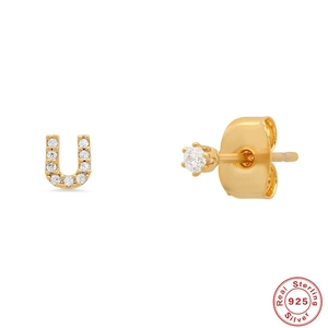 Detailed macro of gold S925 sterling silver initial U stud earrings with micro diamonds