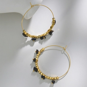 Detail of 14k gold plated hoop earrings with square beads and black turquoise stones