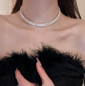 Close-up of double-row pavé diamond choker necklace on model's neck and collarbone