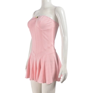 Detail of pink strapless pleated dress showing ribbed texture and metal flower decoration