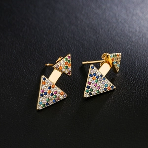 Golden double triangle earrings featuring colorful zircon stones on black leather background