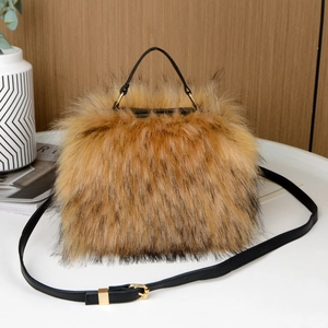 Detail of tan faux fur handbag with black tips, faux leather handles and shoulder strap