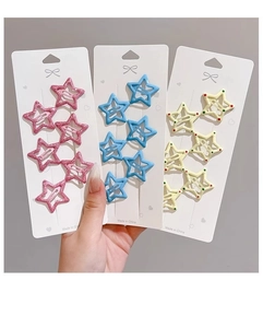 Detailed set of star-shaped hair clips in pink glitter, blue and polka dot patterns