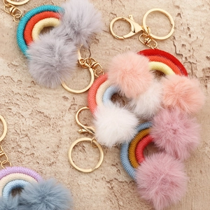 Handmade rainbow cotton woven keychain with plush pompoms and golden metal ring