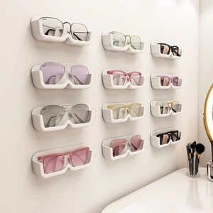 White wall-mounted eyeglass organizer rack with 12 compartments for sunglasses display