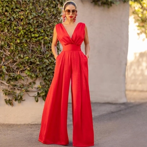 Elegant red deep V-neck sleeveless wide-leg jumpsuit with high waist for women in sunshine