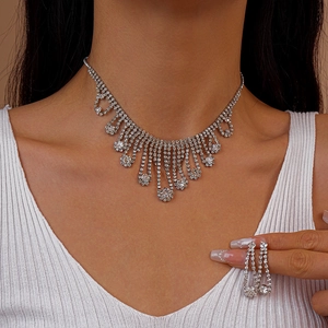 Silver rhinestone tassel necklace and earring set shown on model for elegant bridal look