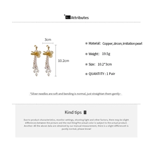 Detailed view of butterfly tassel earrings with zircon and pearls showing 10.2cm length
