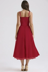 Detail of slim waist cut and back zipper on a dark red floral satin midi dress