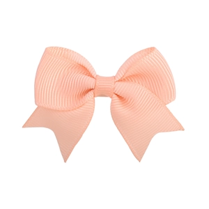 Close-up of apricot grosgrain ribbon hair bow showing elegant texture and simple design