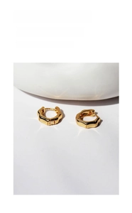 Macro view showing the natural bamboo texture and 18K gold finish of the hoop earrings