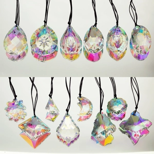 Close-up of fourteen assorted geometric suncatcher crystals with rainbow AB coating