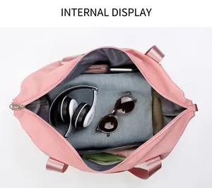 Internal display of large pink travel bag with compartments for clothes and sunglasses