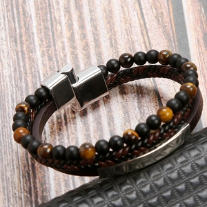 Detail of woven brown leather and tiger eye stone beads with silver magnetic clasp