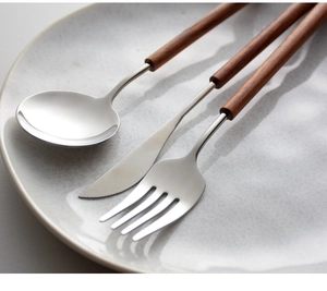Detail view of matte 304 stainless steel cutlery set with Nordic pearwood handles