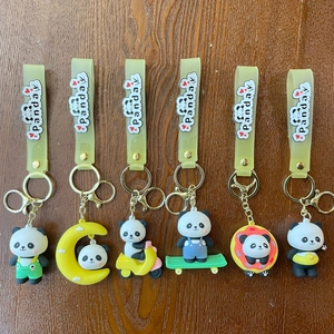 Detailed set of 6 cute cartoon panda PVC keychains with colorful silicone wrist straps