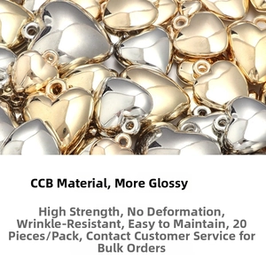 Macro detail of 20pcs heart-shaped CCB beads in polished gold and silver metallic finish