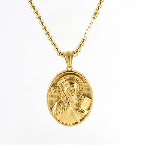 Detail view of 18K gold plated stainless steel 3D St. Benedict relief pendant