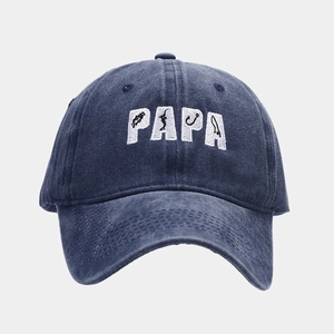 Close-up of PAPA 3D embroidery with fishing motifs on navy washed cotton baseball cap