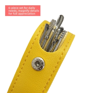 Detail of 6-piece stainless steel earwax removal kit in a bright yellow PU leather case