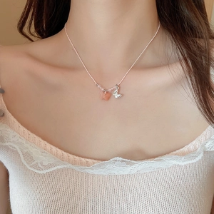 Détail du collier en cordon rose avec double pendentif papillon pour femme
