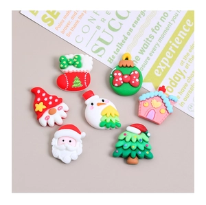Flat lay of colorful resin Christmas DIY charms including snowman and Santa Claus