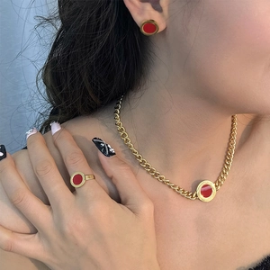 Vintage gold and red enamel jewelry set featuring necklace earrings and ring on model
