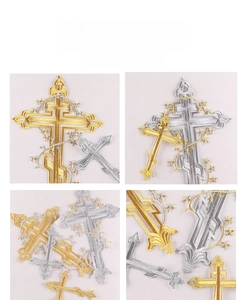 Macro shot of metallic gold and silver embroidered orthodox cross patches with fine vine detail