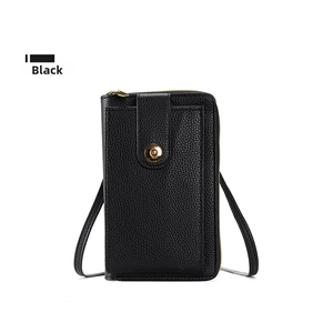 Detail of black pebbled leather crossbody phone bag with gold metal buckle and zipper