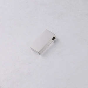 Close-up of polished stainless steel rectangular bead with hole for DIY jewelry making