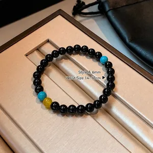 Detail of 6mm black agate beaded bracelet with turquoise accents in a jewelry gift box
